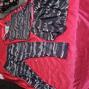 A set of clothing that has black and white music notes printed on it